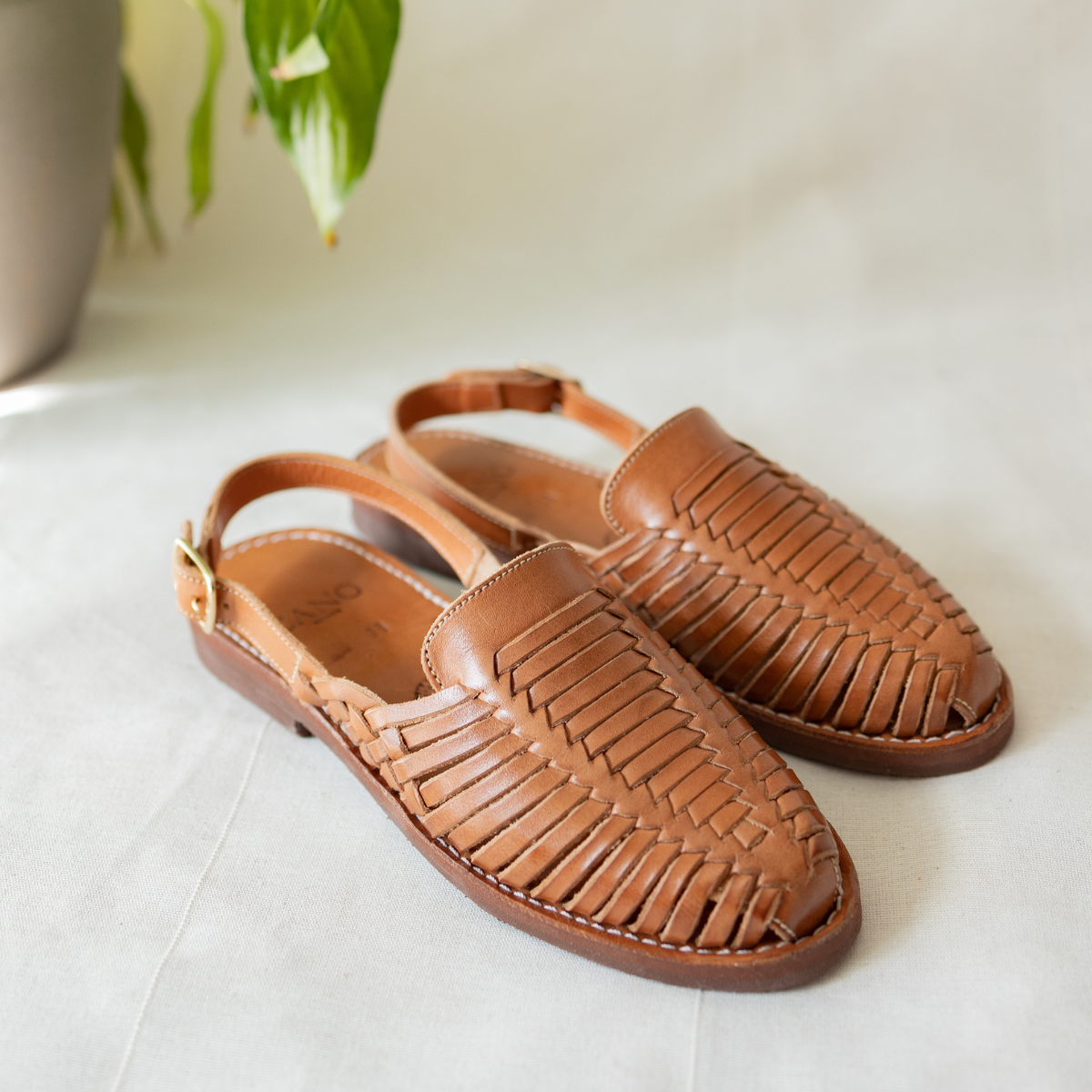 Side view of hand-woven leather Amelia sandal in cognac