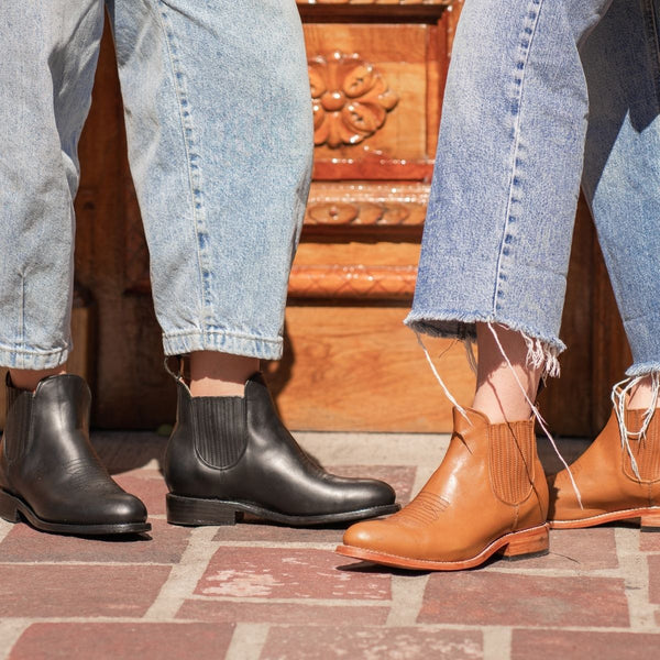 Lifestyle view of Eloisa sustainable charro boot black and cognac